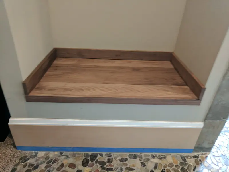 Wall opening finished with a wood sill and fresh white trim where an interior door and wall were removed